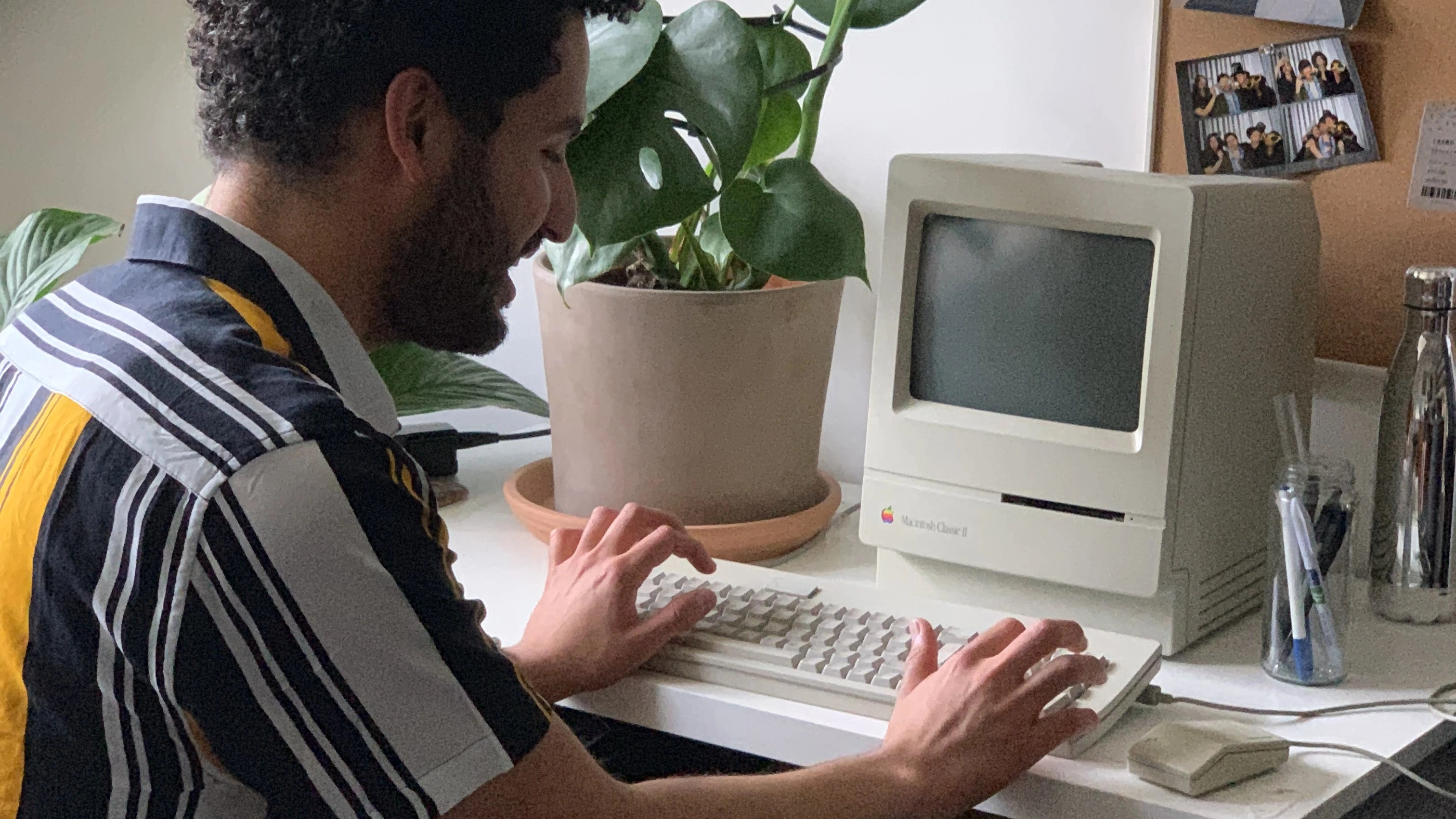 Male types on a old Apple branded Keyboard.