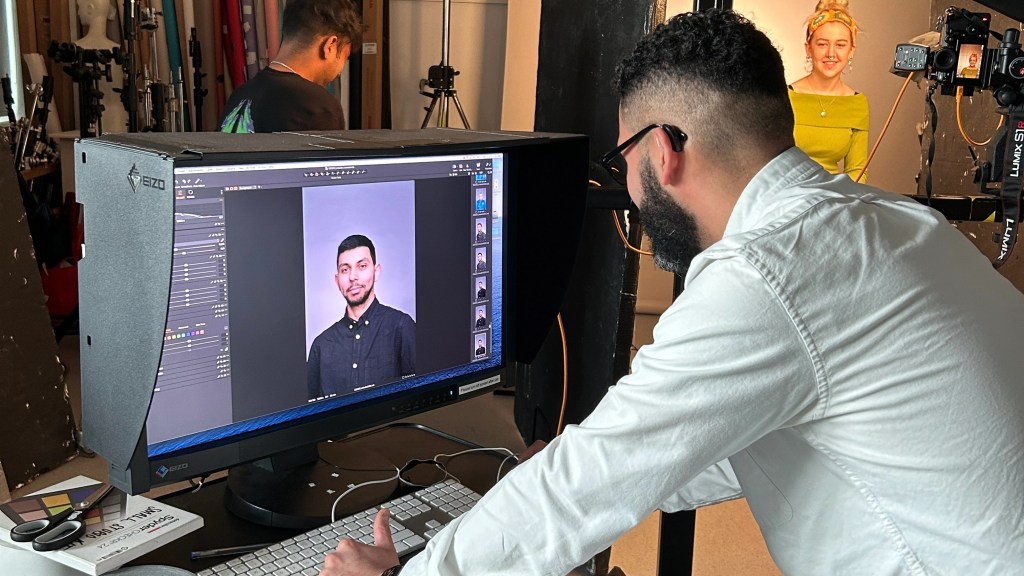 Students in a photography studio taking portraits of other students.